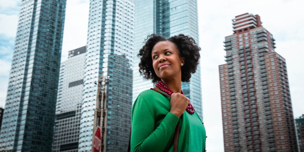 A happy and confident woman in a big city.