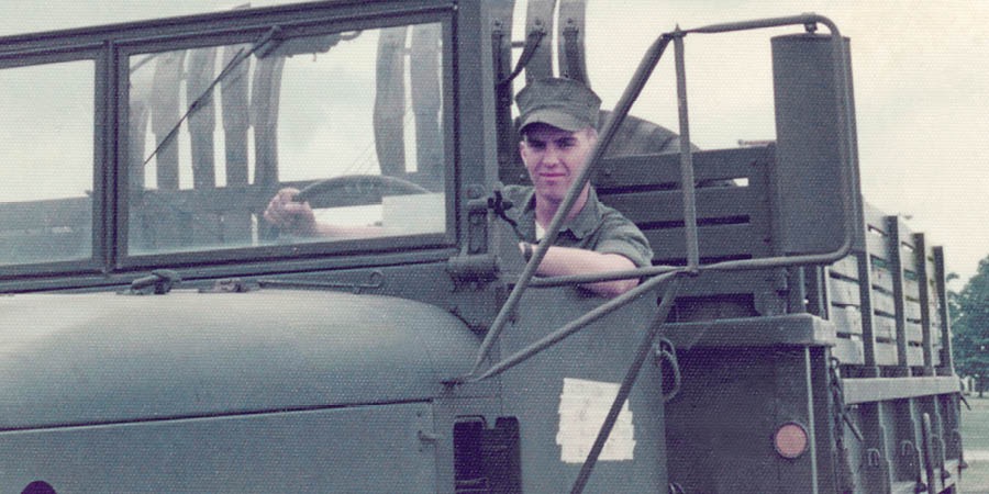 Michael Kuenzle as a member of the U.S. Marine Corps, driving a truck.