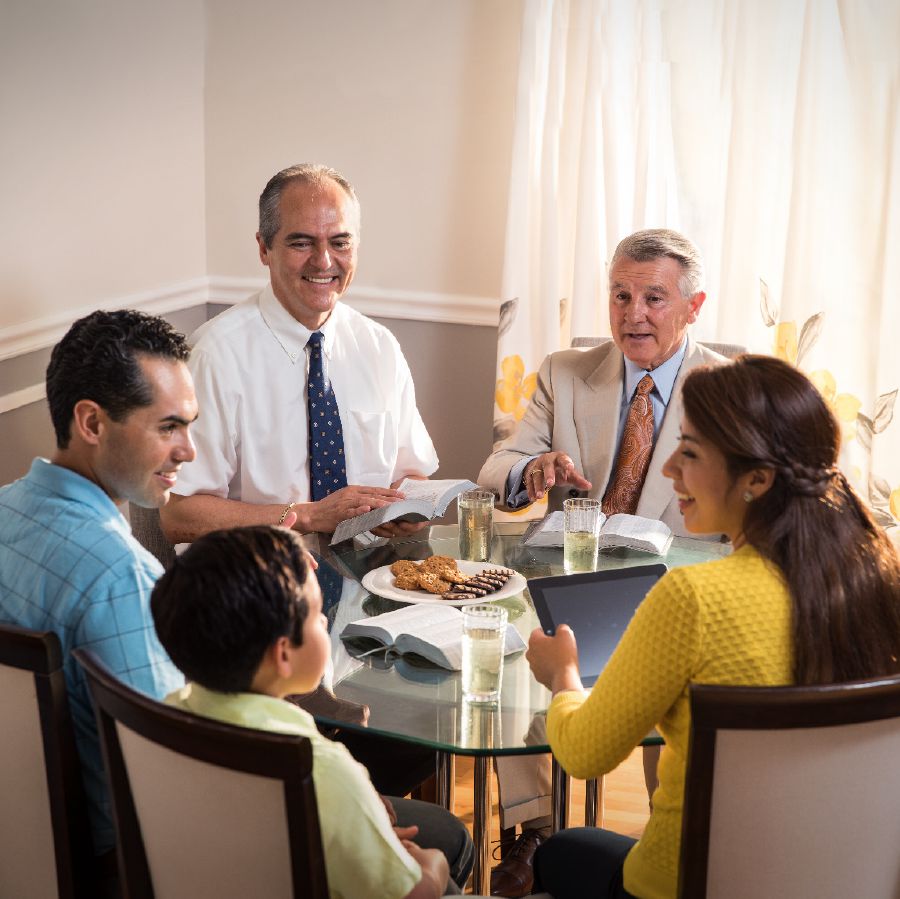 Two elders making a shepherding visit on a family.