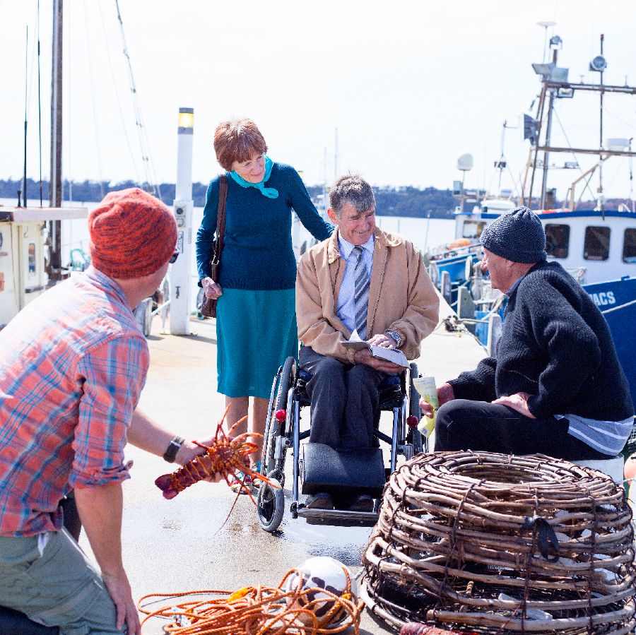 Jehovah’s Witnesses preach to people on a boat dock