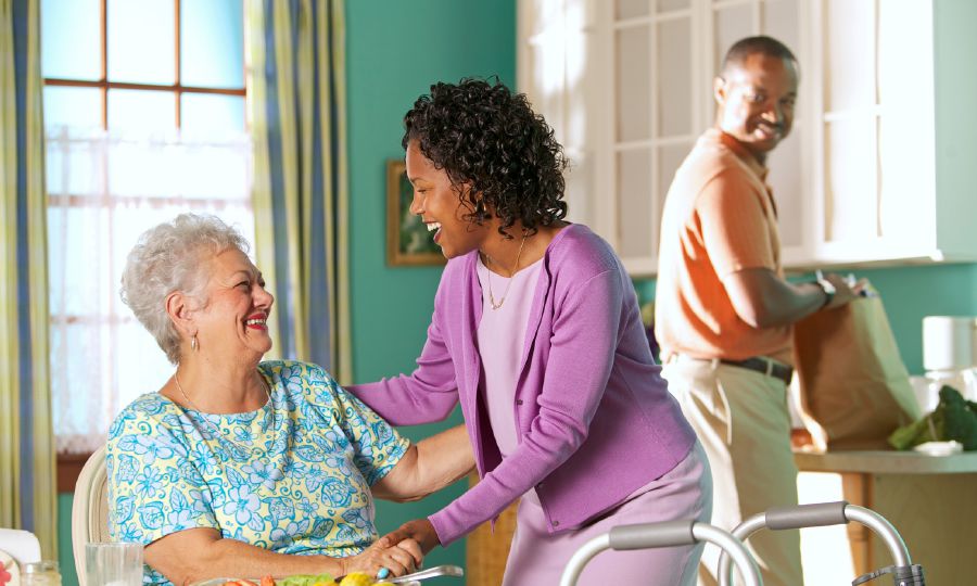 A Christian couple assisting an elderly disabled friend