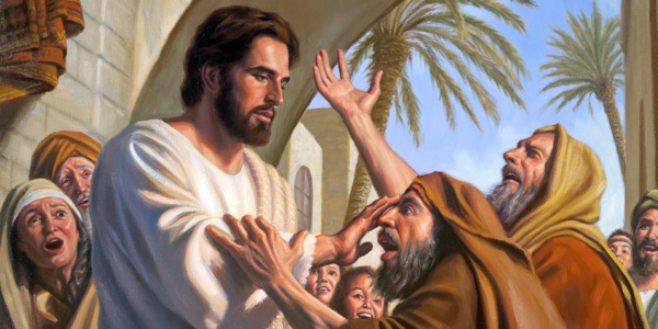 Jesus touches a blind man’s eyes and cures him