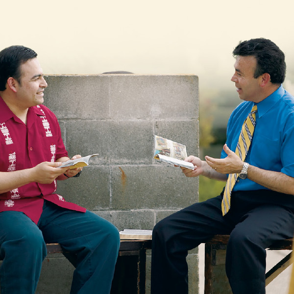 A brother conducting a Bible study with a man.