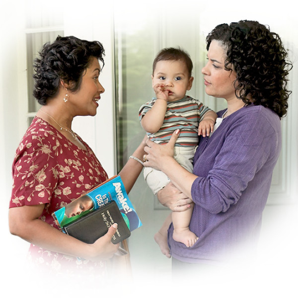 A sister witnessing to a mother holding her baby.