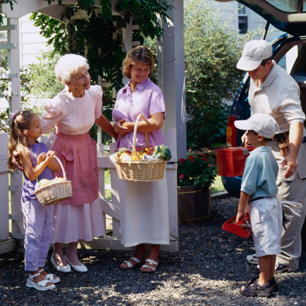 A couple with their two children bringing food and tools to help an elderly sister.