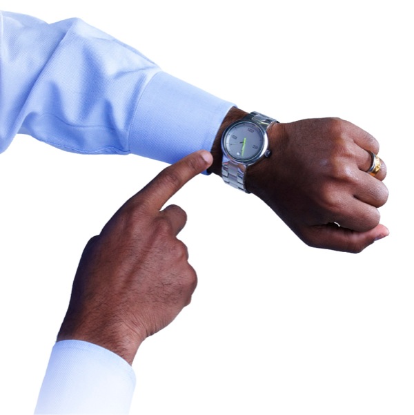 A man pointing to his wristwatch