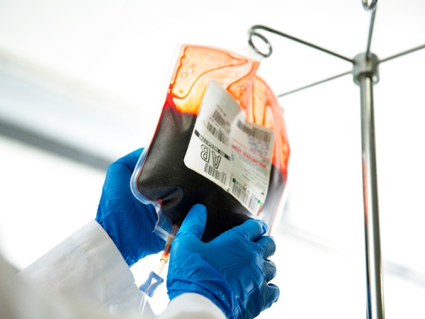 A clinician holding a bag of stored blood
