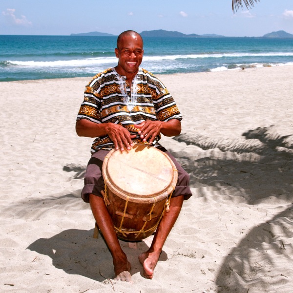 A Garifuna musician plays the hardwood drum