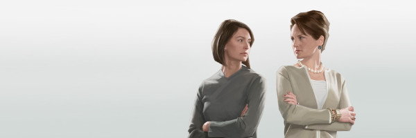 Two women angrily look at each other