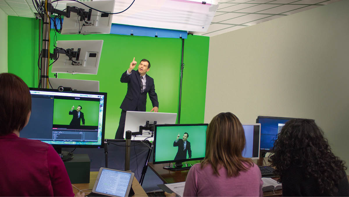 A translation team recording a sign-language publication. The signer stands in front of a green screen.
