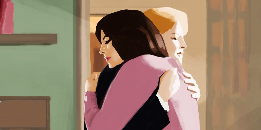 Two women embrace each other