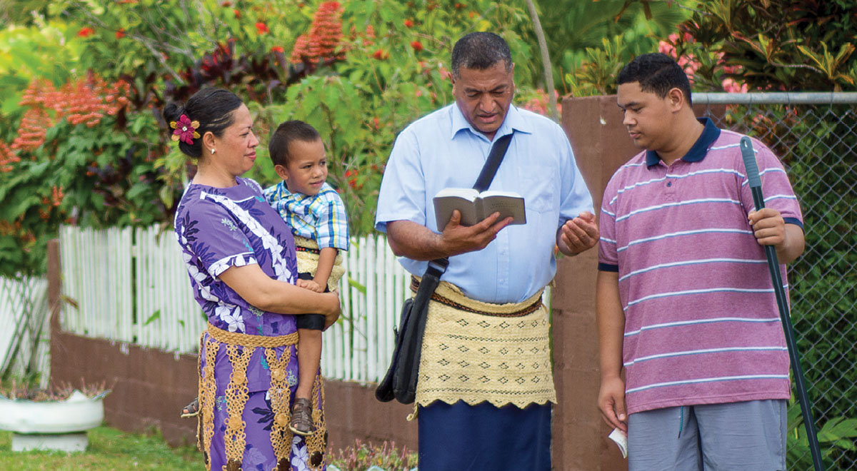 Solomone Tonga and his family teach the Bible to a man