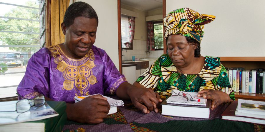 A husband prays with his wife before family worship