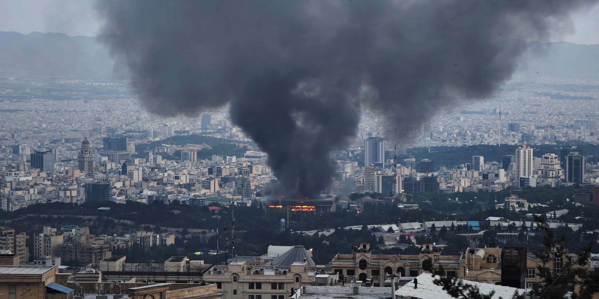 Smoke billowing up from a missile strike on a city in the Middle East.