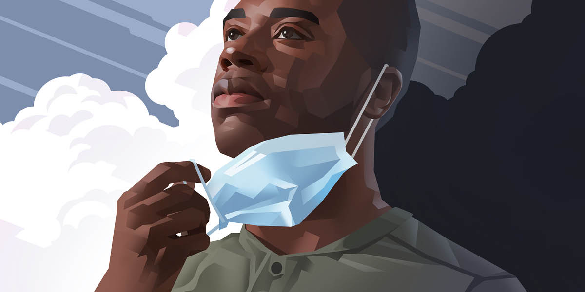 A man removing his facemask and gazing at the brightening sky.