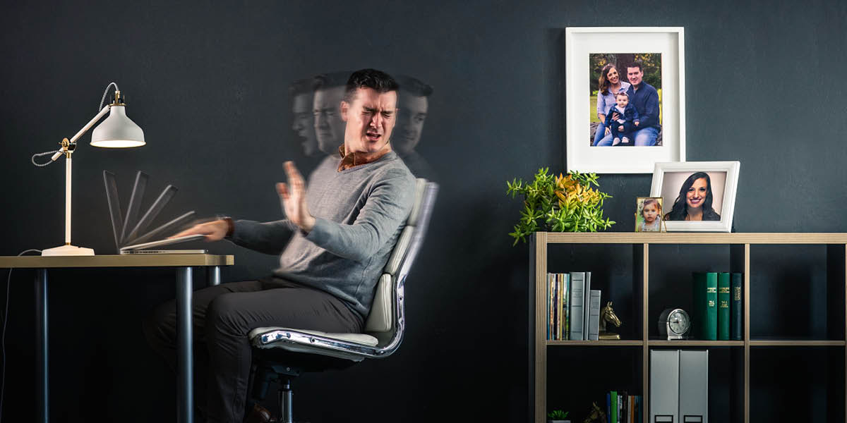 A husband and father turning away in disgust from his laptop computer and quickly closing it.