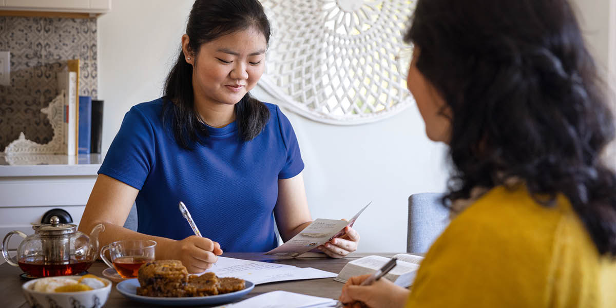 Two of Jehovah’s Witnesses participating in the ministry by letter writing.