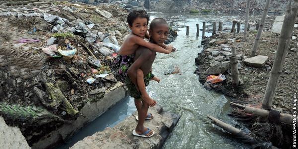 Children play near extremely polluted land and water