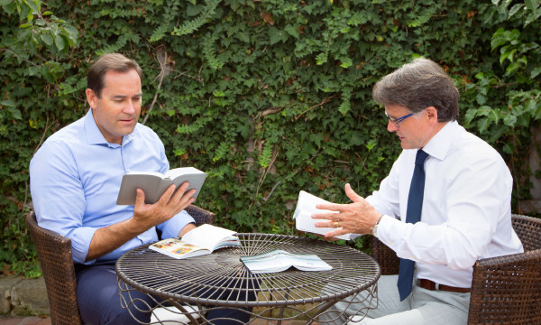 One of Jehovah’s Witnesses conducts a Bible study with a man