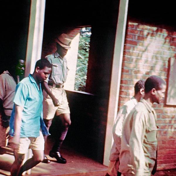 Jehovah’s Witnesses being led away during a trial