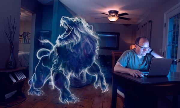 A man looks at inappropriate images on his computer at night; the sketch of a large, smiling lion appears to be in the room