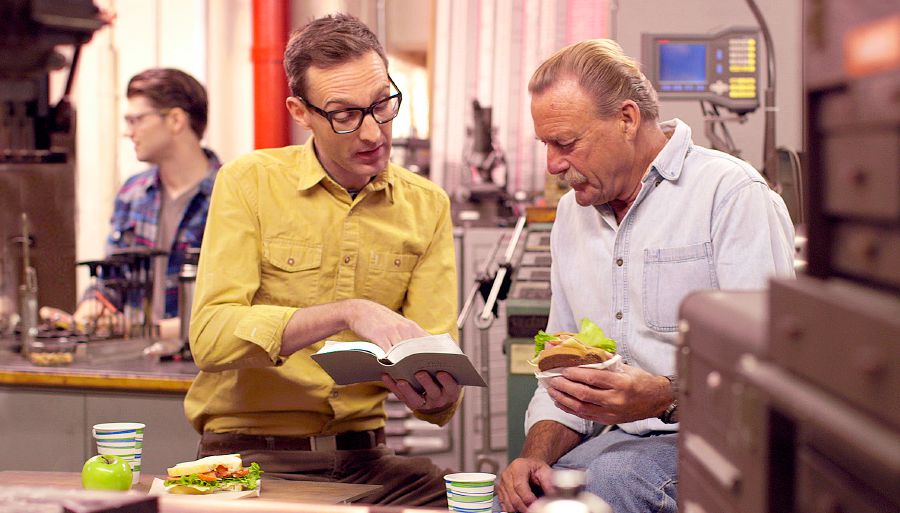 A brother reads a scripture to a man during their lunch break at work