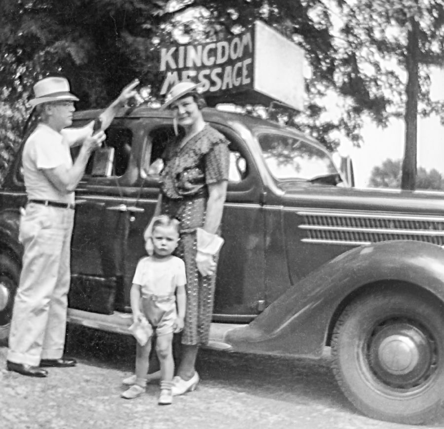 Charles Molohan when he was a little boy stands in front of a sound car with his father and mother