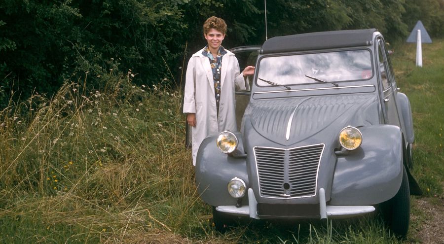 Danièle Bockaert stands beside their small car