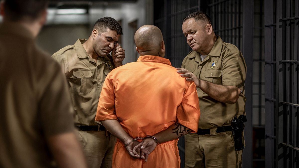 A reenactment of Jack being led away by saddened prison guards. One of the prison guards wipes away tears from his eyes.