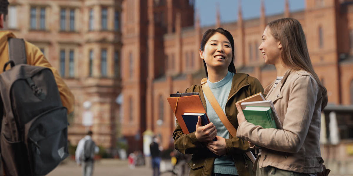 Two young women walking to class at a university.