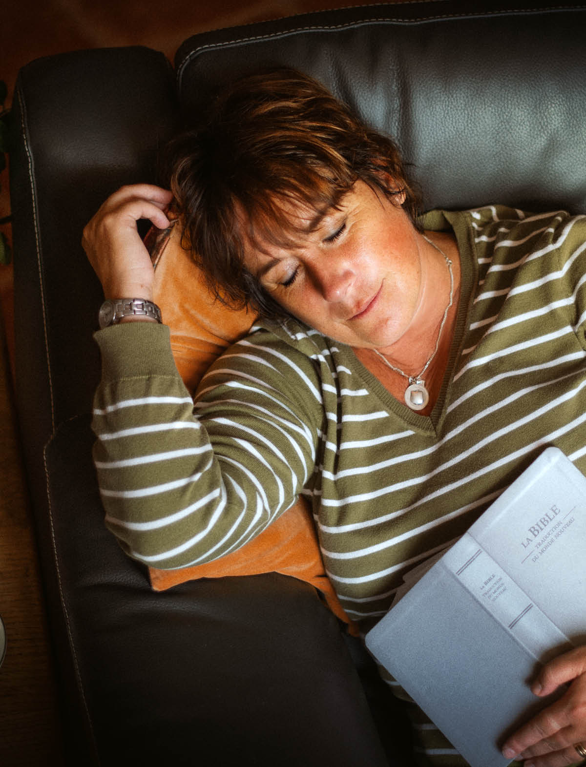 Jessica falling asleep with an open Bible in her hand.