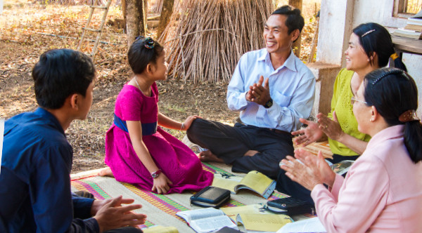 A Christian father studies the Bible with his family