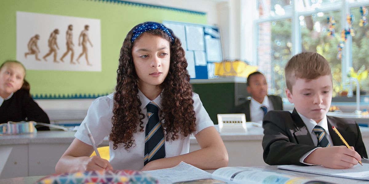 A young sister sits in a classroom where evolution is taught