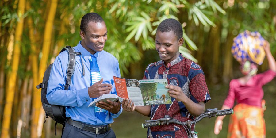 A brother offers an Awake! magazine to a man