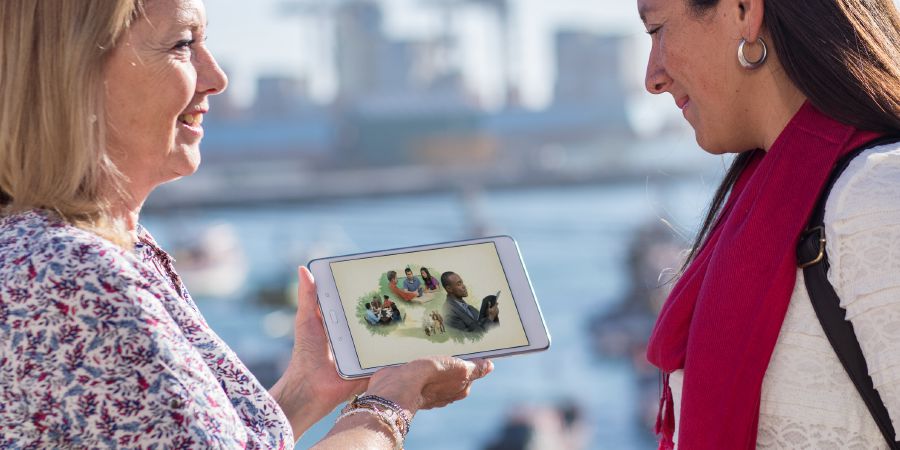 A sister shows a woman the video Why Study the Bible?