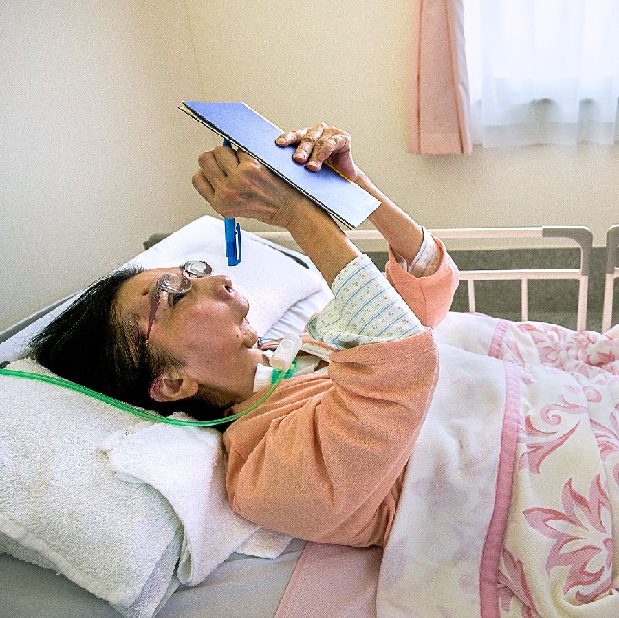 In Japan, Kazumi writes a letter from her hospital bed