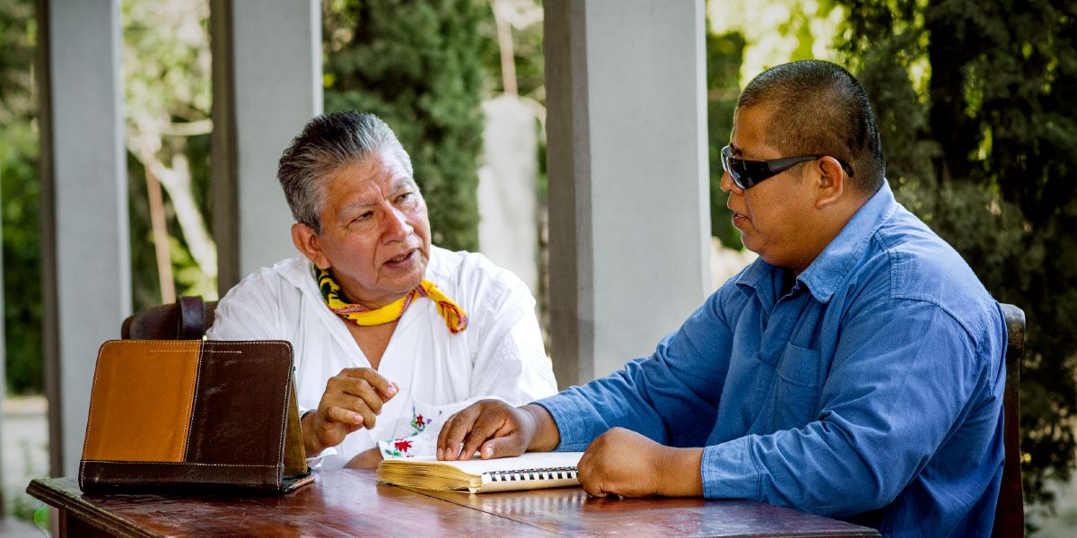 Ángel and Ismael read Braille together