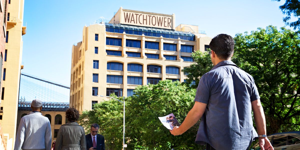 With an invitation to the open house in hand, a man approaches 25 Columbia Heights, Brooklyn, New York