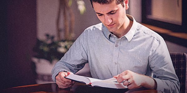 مردی در حال خواندن کتاب مقدّس