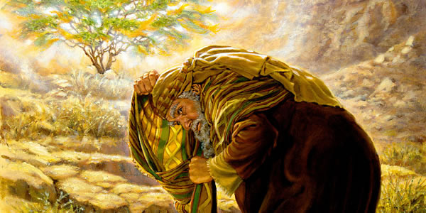 Musa menutupi wajahnya di depan semak berduri yang terbakar.