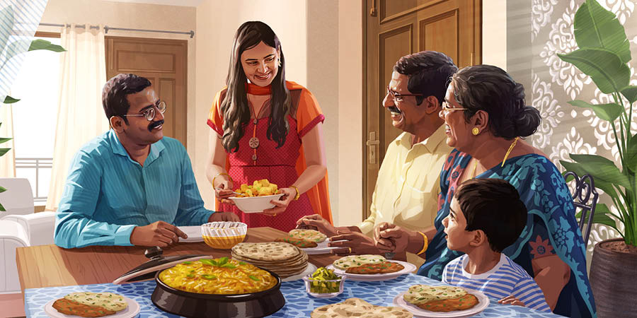 Una famiglia mangia qualcosa insieme a degli ospiti in casa.