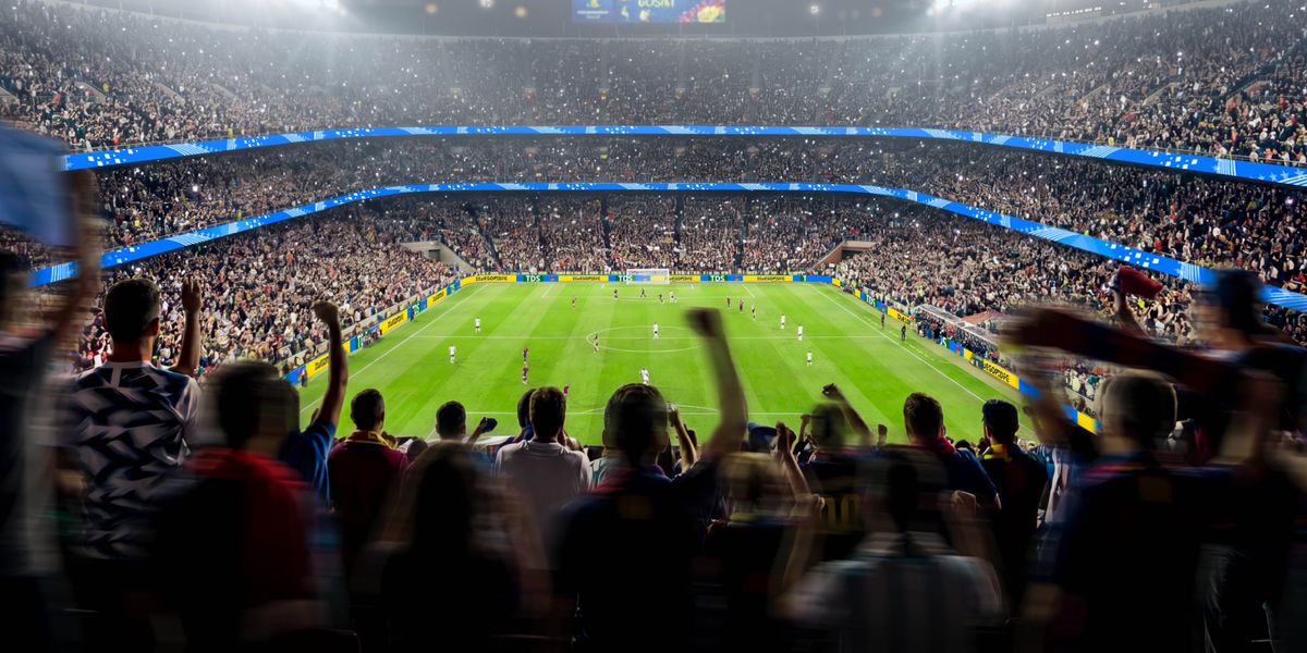 Uno stadio pieno di tifosi che esultano mentre guardano una partita della Coppa del Mondo.