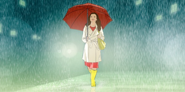雨の中を歩いている十代の女の子