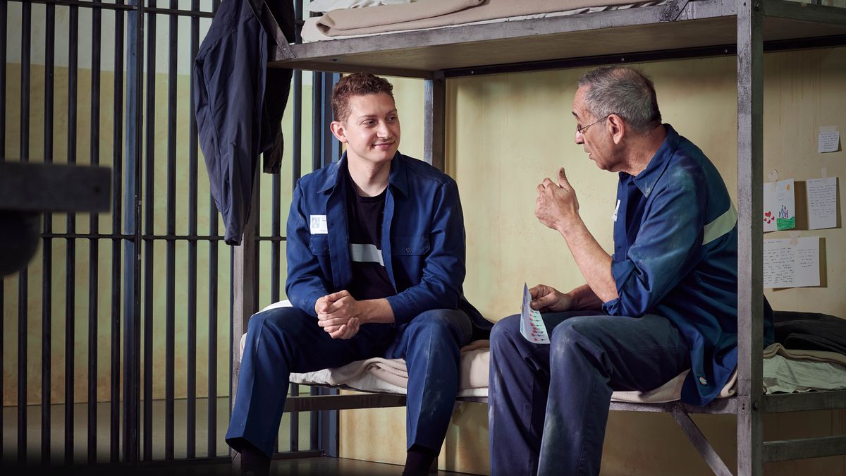 Bana betu ba balume babidi basombe pa bulalu mu buloko bayukila. Mikanda, karte, ne bimfuanyi bizola pa mabeji bilamika ku tshimanu panyima pabu.