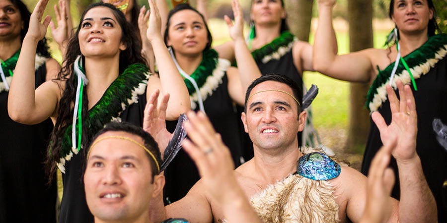A tribo maori dançando com roupas tradicionais