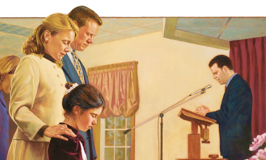 Uma família escuta uma oração feita numa reunião
