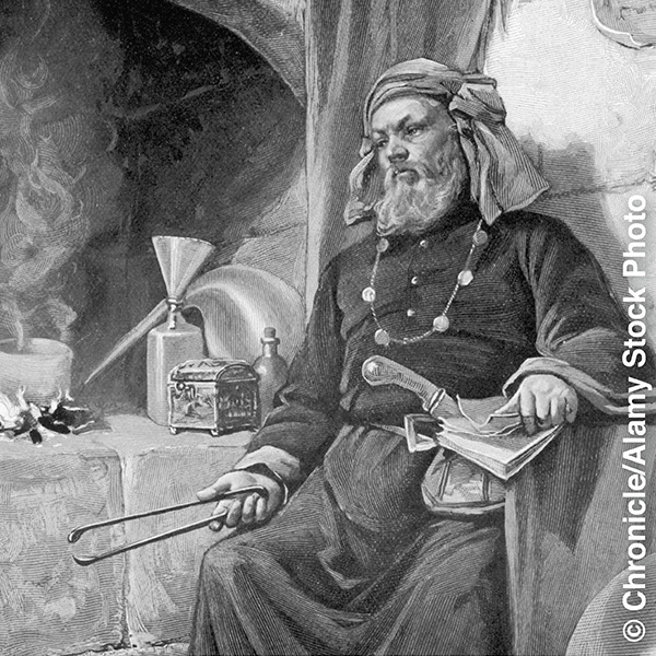 Um alquimista da época medieval em seu laboratório