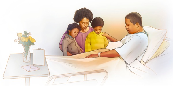 Un omo nte un leto de ospital insieme cola so fameia