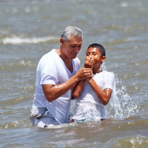 A young man being baptized in Nicaragua